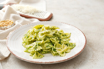 Plate with tasty pesto pasta on table