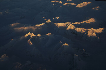 Nature scene - Aerial view of Snow Mountain and light of sunrise on the top  himalaya mountains from the plane at Leh Ladakh , Jammu and Kashmir , India - beautiful scene 