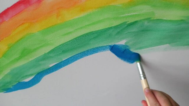 kid drawing art with paints colorful rainbow