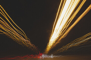 Light trails of street lights and cars on a busy road at night