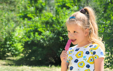 Close up stylish  child girl enjoying pink ice cream outside. Pretty little girl eating ice cream walking summertime.