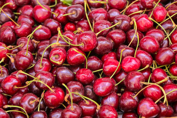 Fresh shiny red cherry in the boxes on the market stall