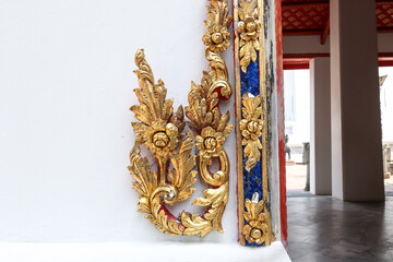 Gilded stucco designs decorate the door frames at Wat Pho or Wat Phra Chetuphon Temple (Wat Pho - reclining Buddha). Travel destination in Bangkok, Thailand.