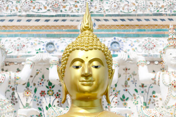 Buddha image at the Temple of Dawn or Wat Arun is best known for its massive prang, a tower on the...