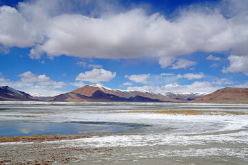 Nature Scene of Landscape Tso kar lake is salt lake and dry meadow with snow mountain background at Leh Ladakh ,Jammu and Kashmir , India - unseen travel and vacation park and outdoor