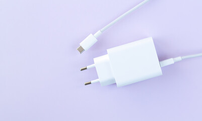 Mobile phone charger for fast charge USB cable on purple background
