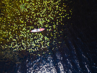 Aerial view from a drone of a person who floats on a sup