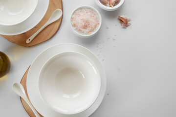 Fototapeta na wymiar Empty white dishes on table, space for text