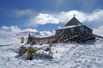 Landscape traditional pavilion with tibetan flag on white Snow mountain  at  Taglang La or Tanglang La pass Leh Ladakh ,Jammu and Kashmir , India