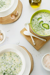Summer refreshing cold yogurt soup, healthy meal with fresh raw vegetables and dairy ingredients