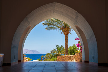 Beautiful arched doorway in a building on the shores of the Red Sea at morning in the resort town...
