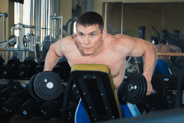 Fototapeta na wymiar Training in the gym, muscular man. Sexy guy