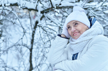 Fototapeta na wymiar Happy beautiful senior woman in warm hat