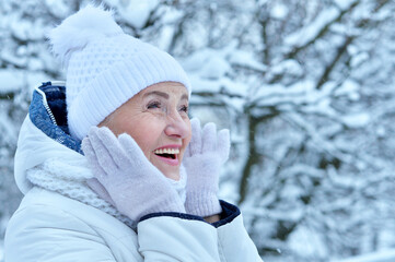 Happy beautiful senior woman in warm hat