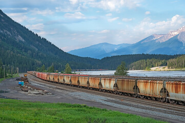 Freight train on the banks of the Kicking Horse River at Field, British Columbia, Canada