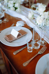 Beautiful table setting for a party, wedding reception or other festive event. Banquet setting, glasses, plates.