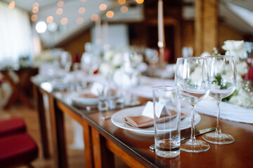 Beautiful table setting for a party, wedding reception or other festive event. Banquet setting, glasses, plates.