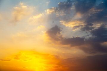 Naklejka na ściany i meble Golden sky with clouds at sunset