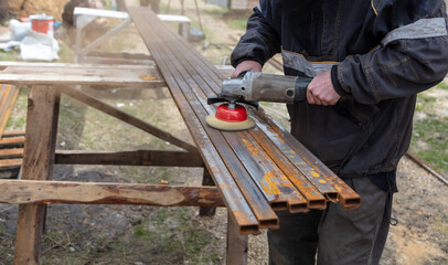 A worker grinds metal at a construction site.