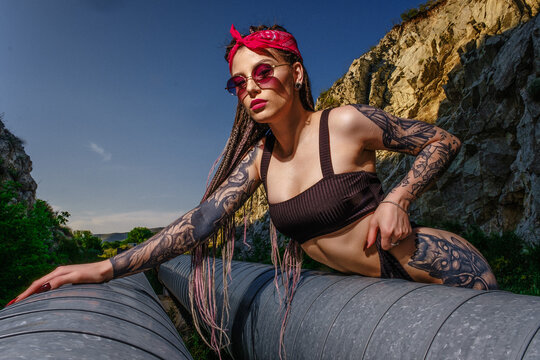 woman sitting on a pipeline