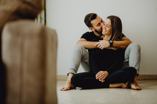 Happy couple hugging on floor