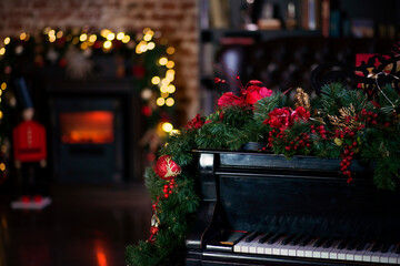 Black piano, against the background of a fireplace decorated with Christmas garlands, New Year card