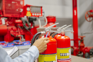 Engineer inspection Fire extinguisher and fire hose,Ready to use in the event of a fire.Safety first concept.