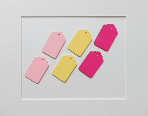 carefully arranged retro wooden tags on paper background with accent frame