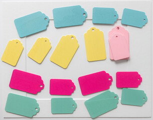 rows and pile of retro wooden tags on paper background with accent frame