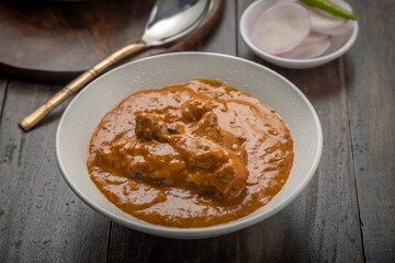 chicken butter masala served in a white bowl