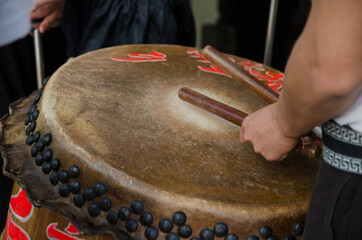Drumsticks beating on a Chinese traditional drum.