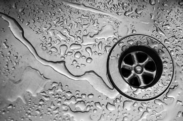 Water on Stainless steel kitchen sink drain.