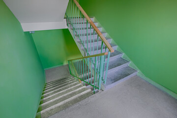 Building panel house interior with flight stairs and green walls. Precast concrete staircase. Flight of stairs. Flight of stairs are decorated building. Beautiful long staircase. Tile on floor.