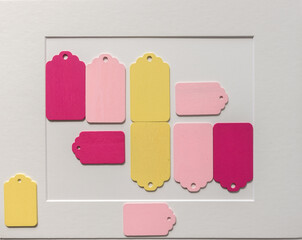 old school or retro chalkboard tags, loosely arranged on a light paper background, with a mat board...