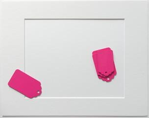 old school or retro chalkboard tags, loosely arranged on a light paper background, with a mat board accent frame, and photographed from above in a top-down style with ambient light