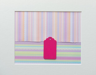 old school or retro chalkboard tag arranged on a patterned paper background, with a mat board accent frame, and photographed from above in a top-down style with ambient light