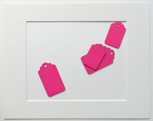 old school or retro chalkboard tags loosely arranged on a light paper background, with a mat board...