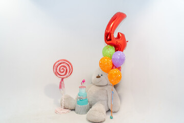 White children's photozone with huge soft bear and balloons