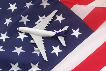 Airplane model on USA flag. Aviation law, travel and transportation in United States concept.