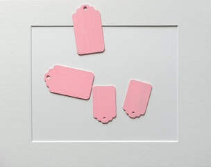 old school or retro chalkboard tags loosely arranged on a light paper background, with a mat board...
