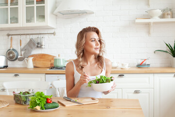 Obraz na płótnie Canvas Healthy lifestyle and diet. Healthy young woman eating vegetable salad. Beautiful blonde woman with mixed vegetable at home