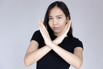 woman saying no with rejecting hand gesture and negative facial expression