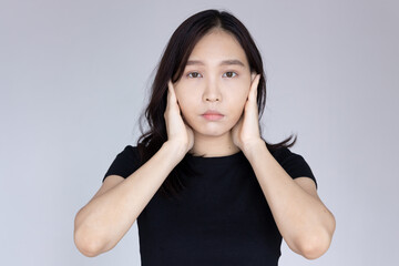 young woman covering her ears, concept of censorship, free speech limitation, press freedom, news manipulation, hidden truth, secret, disinformation, gossip, rumor, fake news