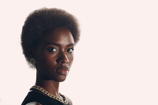 Close up natural portrait of african american woman with afro hairstyle on white studio background.