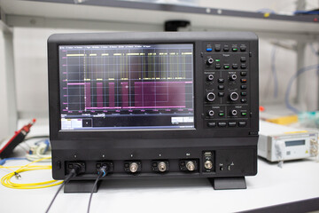 Professional digital oscilloscope oscillograph at tech lab.