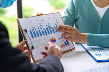 Business partnership coworkers using a laptop to analysis graph company financial budget report and...
