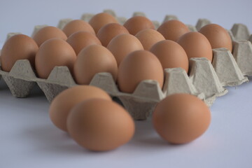 A bunch of eggs with corrugate box and bowl with natural morning light