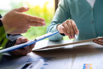 Financial advisor teamwork and accounting concept, Business People Meeting to analyze and discuss and brainstorming the financial report chart data in the office