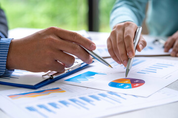 Business People Meeting to analyse and discuss and brainstorming the financial report chart data in office Financial advisor teamwork and accounting concept.