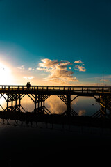 Colourful sunset panorama of Picturesque bridge and lighthouse of the Milnerton lagoon in Cape Town, South Africa.